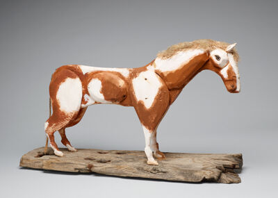 Weathered and painted wood, baling twine, hair on wood